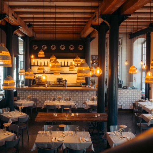 Catch of the Day mit Bar und warm beleuchteten Tischen
